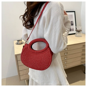 Chic red glitter handbag with embossed stripes shown in a stylish crossbody carry style