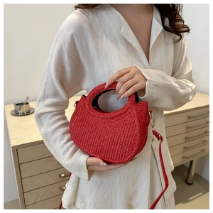Detail of red crescent woven handbag with shimmering sequins and leather strap