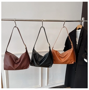 Three minimalist large capacity hobo bags in red-brown, black and caramel leather colors