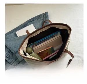 Top view of beige canvas tote bag interior showing capacity for books and tablet