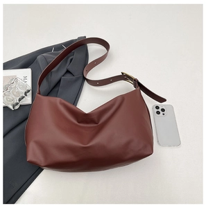Detailed top view of large burgundy hobo shoulder bag with leather texture and metal buckle