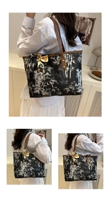 Detail of large tote bag with bamboo embroidery, leather handles and printed silk scarf