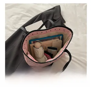 Internal view of pink quilted tote bag showing spacious storage for daily essentials