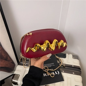 Deep red leather evening clutch bag with unique gold wavy metal decoration and chain