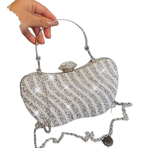 Elegant silver rhinestone evening clutch bag with wave patterns and metal top handle