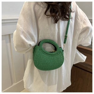 Detail of green sequin tweed crescent bag with integrated handle and gold hardware
