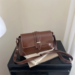 Vintage brown leather crossbody bag with white contrast stitching and metal buckle