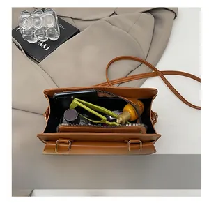 Internal view showing large storage capacity of brown leather crossbody handbag