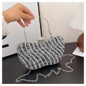 Sparkling crystal rhinestone evening clutch bag with round metal handle and chain strap
