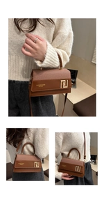 Detail of a brown leather patchwork handbag featuring a golden metal ring handle and logo