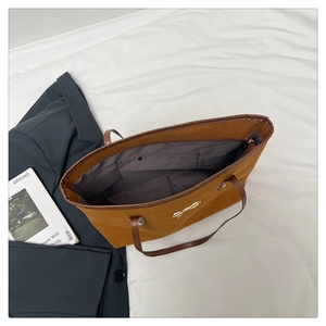 Detail view of large tote bag interior showing zipper pocket and textured suede finish