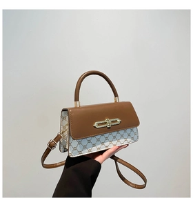 Detail of vintage square crossbody bag with brown leather flap and monogram pattern