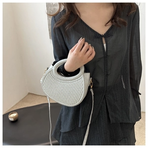 Silver crescent shoulder bag with vertical pleated texture shown on model
