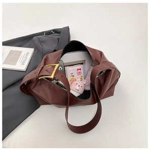 Brown leather tote interior showing storage capacity for phone, wallet and books
