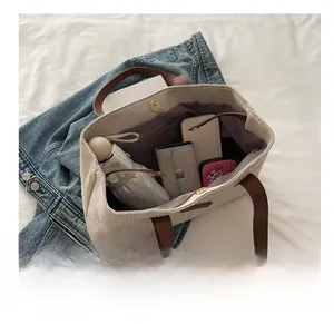 Interior view showing large capacity storage for phone and wallet in the tote bag