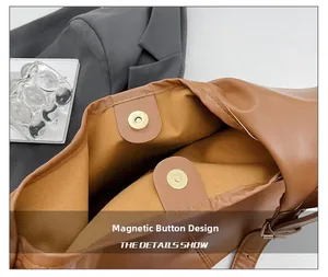 Detail view of the brown leather tote bag showing its magnetic snap button closure design