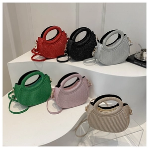 Detailed view of six colorful glitter handbags with vertical texture and metal straps