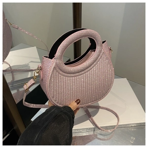 Detail of a pink crystal crescent handbag with sparkling rhinestones and a top handle