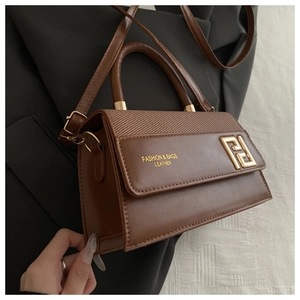 Detail of brown leather bag featuring textured patchwork and golden F-style metal lock