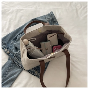 Internal view showing large storage capacity of canvas tote bag with personal items