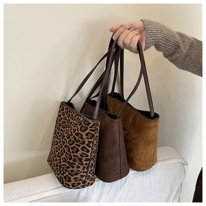 Chic suede bucket bags in leopard print, dark brown, and camel shown with dual shoulder straps