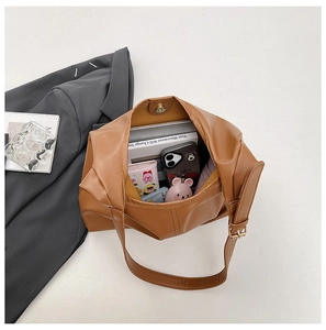 Interior view of large brown bucket bag showing spacious storage for daily essentials
