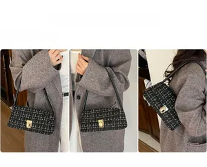 Detail of elegant black tweed shoulder bag featuring gold thread and metallic swivel lock