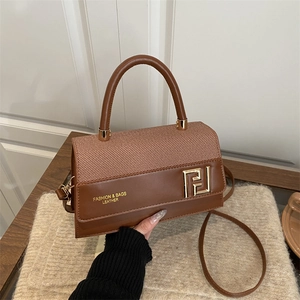 Chic brown patchwork shoulder bag with gold metal hardware and adjustable strap