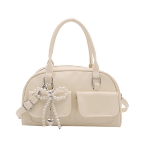 Elegant cream Boston handbag with pearl bow charm and adjustable strap for women