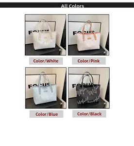 Detail view of large tote bags with embossed texture and colorful embroidery in four colors