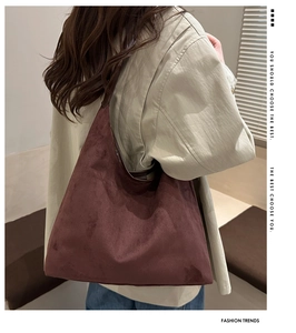 Detail of dark brown suede tote bag showing soft texture and spacious slouchy design
