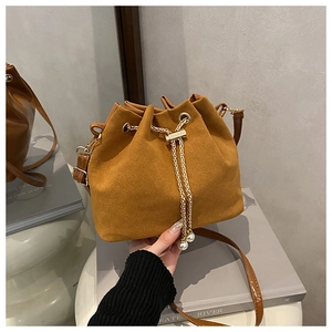 Detail of frosted bucket bag showing drawstring gold chain and pearl accents