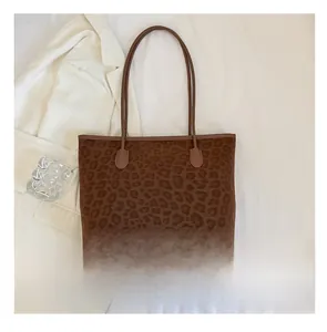 Detailed top view of large leopard print tote bag with phone for size comparison
