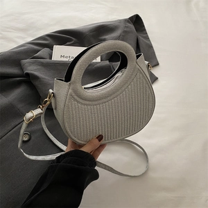 Silver glitter crescent handbag with gold hardware and adjustable strap in lifestyle setting