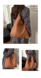 Detail of caramel brown woven leather tote bag showing large capacity and Intrecciato weave