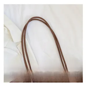 Close-up of comfortable shoulder straps on leopard print tote bag with neat stitching