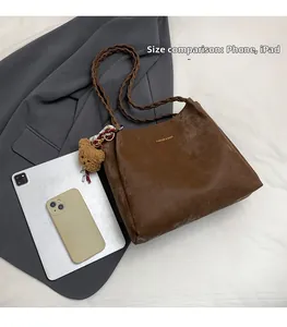 Large brown tote bag with woven strap showing phone and iPad size comparison