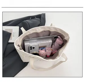 Interior view showing large capacity for tablet, umbrella, and makeup in a white tote bag