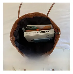 Macro view of the large capacity tote bag interior with multiple everyday items