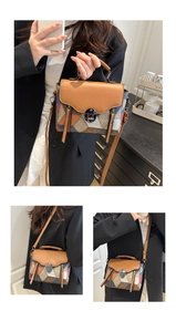 Detail of color block handbag showing the leather texture and vintage metal lock buckle