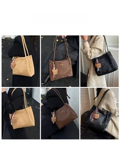 Three-color matte suede tote bags shown on models with woven straps and bear charms