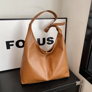 Brown faux leather hobo bag with large capacity and adjustable shoulder strap for daily commuting