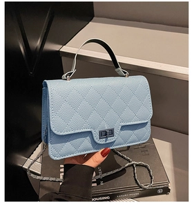Close-up of light blue quilted leather handbag featuring metal twist lock and chain strap