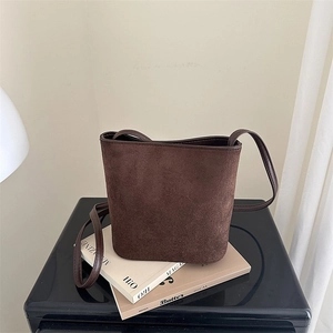 Retro dark brown suede bucket bag with slim shoulder strap for minimalist fashion style