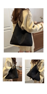 Detail of minimalist black matte suede tote bag shown in a warm indoor setting