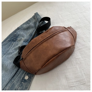 Detailed view of the brown PU leather texture and adjustable strap of the chest bag