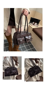Detail of dark brown patent leather shoulder bag with bow-knot pockets and retro style