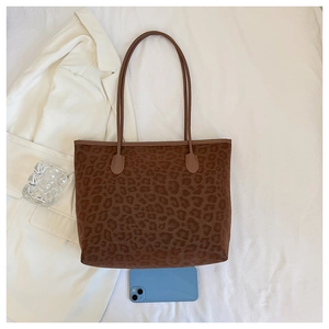 Top-down view of a vintage leopard tote bag with a smartphone to show large capacity