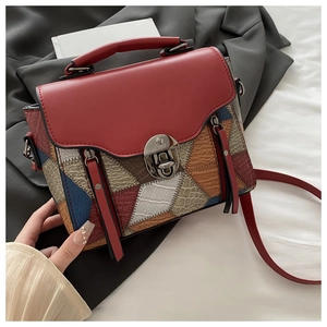 Close-up of retro square bag with mixed animal textures and silver metal buckle lock