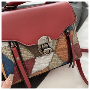 Detail of multi-color patchwork PU leather crossbody bag with silver round push lock